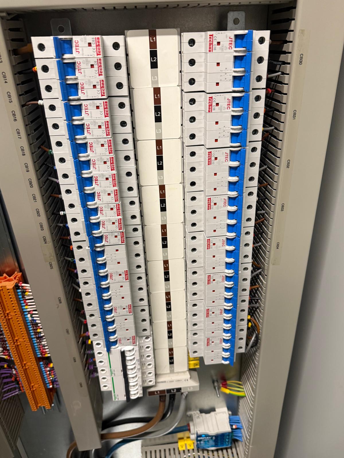 Three-phase distribution breakers inside a BMS panel at 70 Gray's Inn Road during the site optimisation